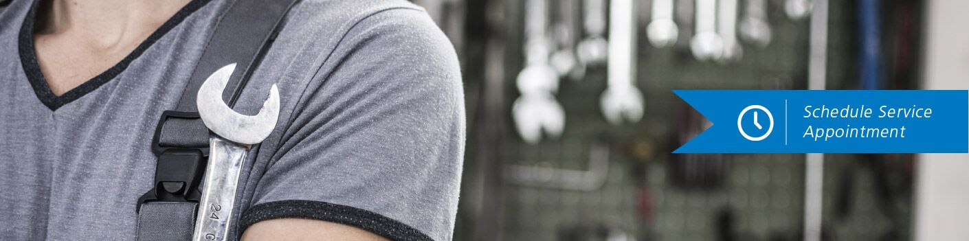 Mechanic holding wrench with "Schedule Service Appointment" on right