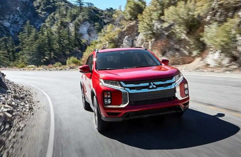 2020 Mitsubishi RVR red driving around curved rocky road