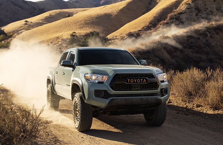 2022 Toyota Tacoma Silver Sky Metallic driving on a dirt road