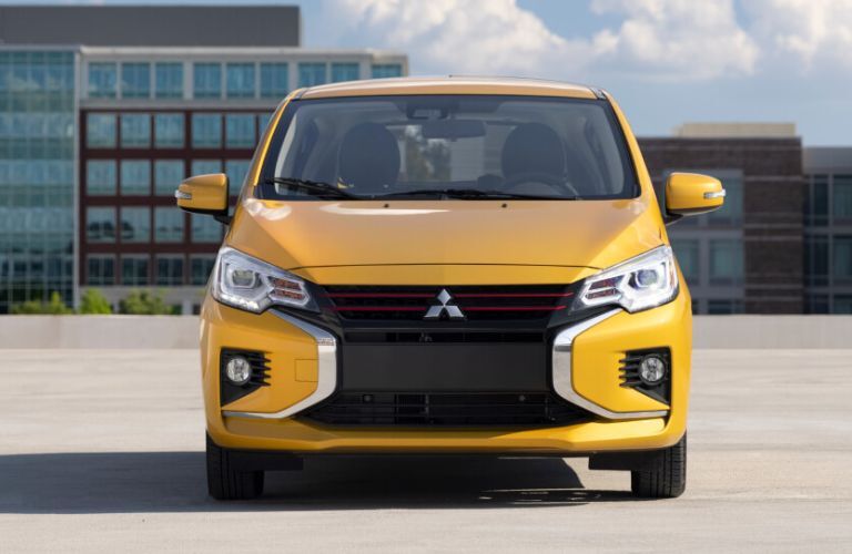 Front end of a yellow metallic 2022 Mitsubishi Mirage parked outdoors