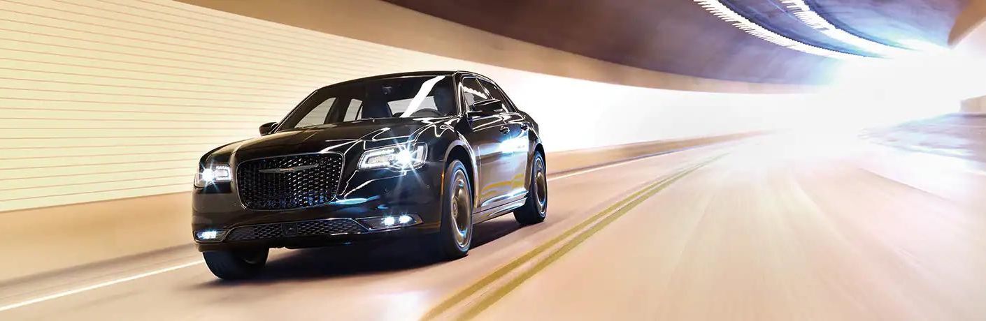 One black color 2022 Chrysler 300 is running on the road