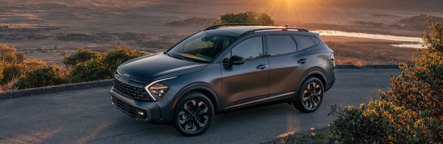 2024 Kia Sportage Plug-In Hybrid Gray during a sunset