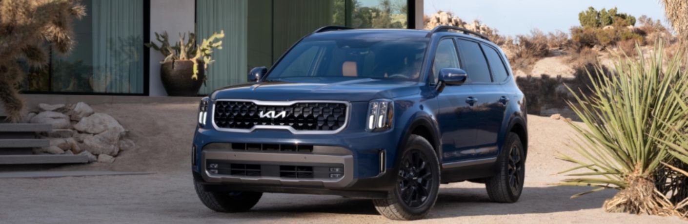 A 2024 Kia Telluride parked in front of a house