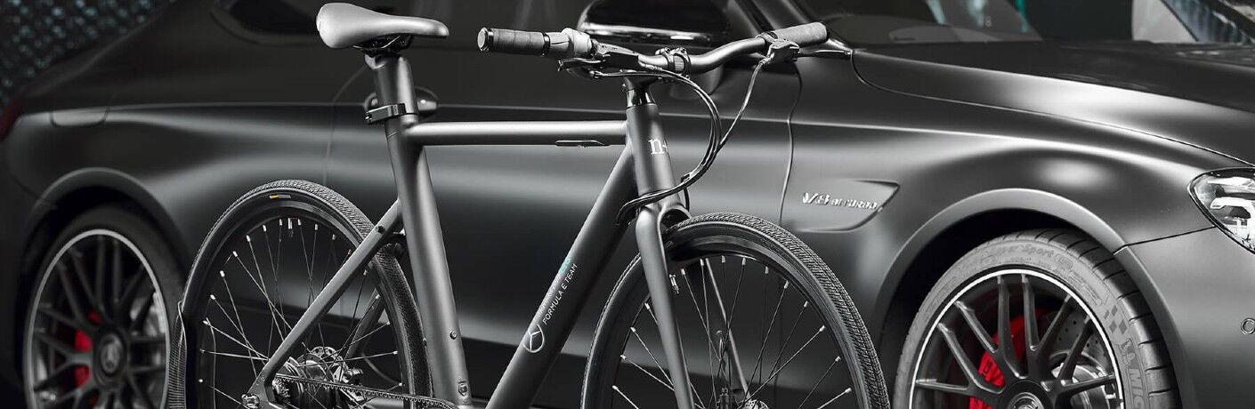 n+ eBike parked next to Mercedes Benz vehicle