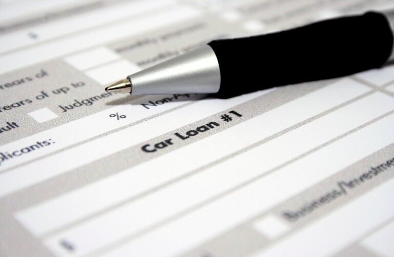 Close up of a car loan application and pen on top