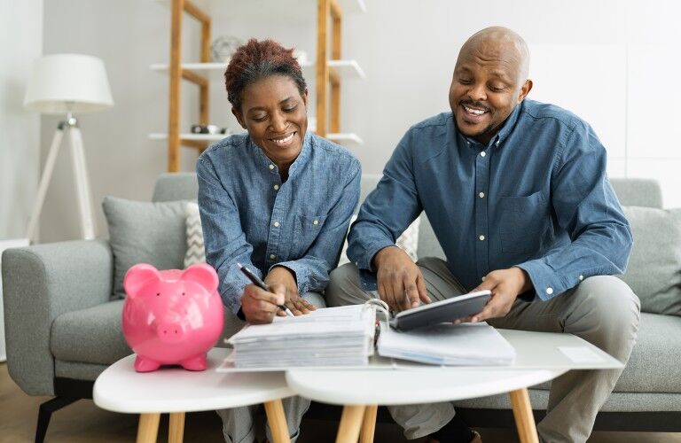 Happy couple reviewing their finances