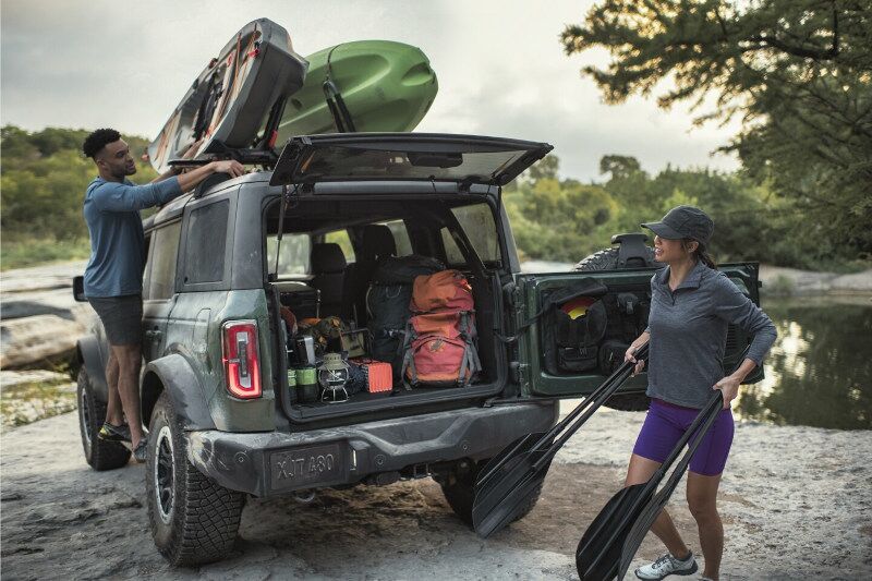 People loading gear into and onto the 2023 Ford Bronco