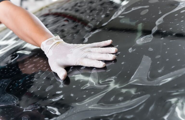 Hand pushing on a windshield