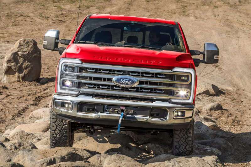 A front view of the rugged Ford F-250 Super Duty on challenging, rocky terrain.