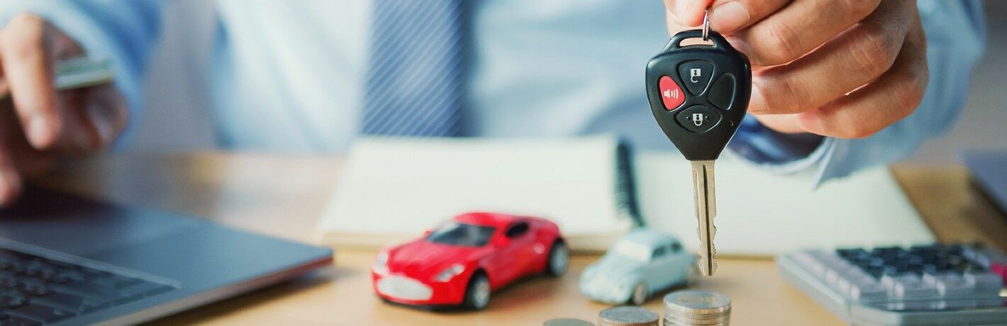 Car salesman holding a car key