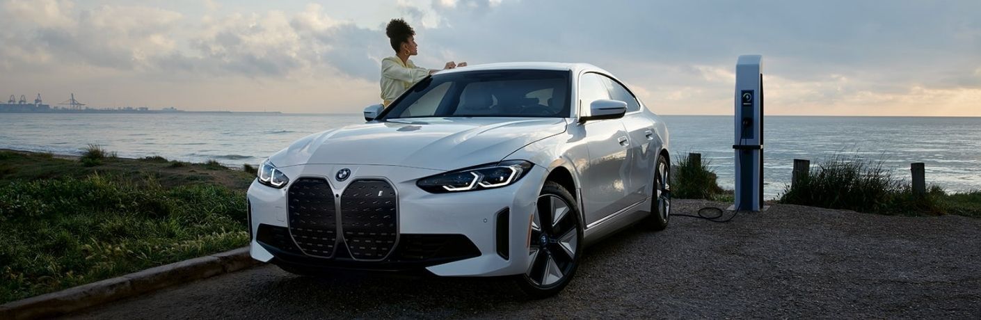2022 BMW i4 with a woman standing near it
