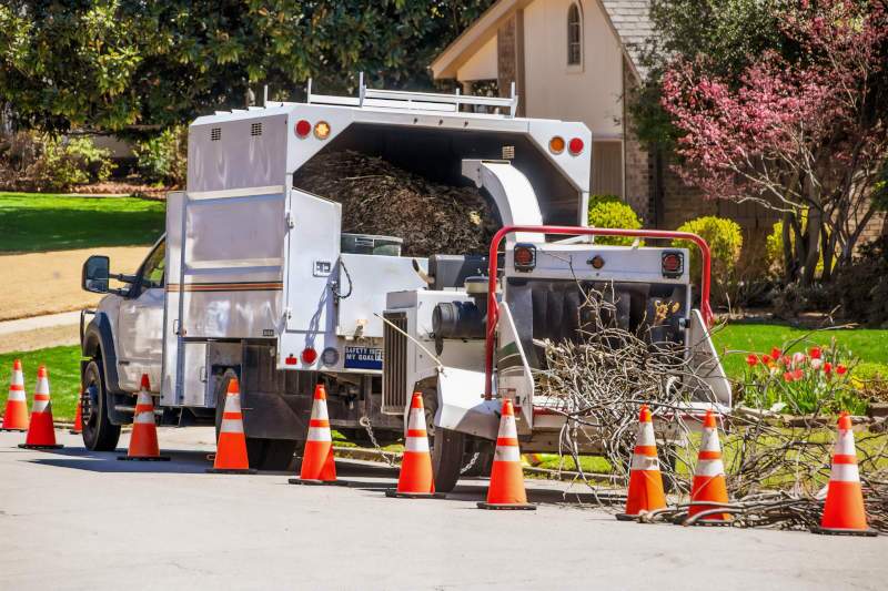 A landscaping truck with a chipper shredder.