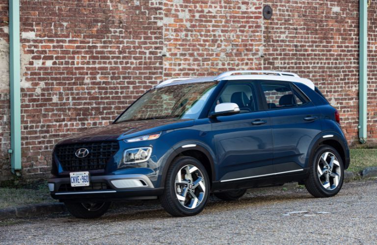 A 2019 Hyundai Venue parked on the side of a city road
