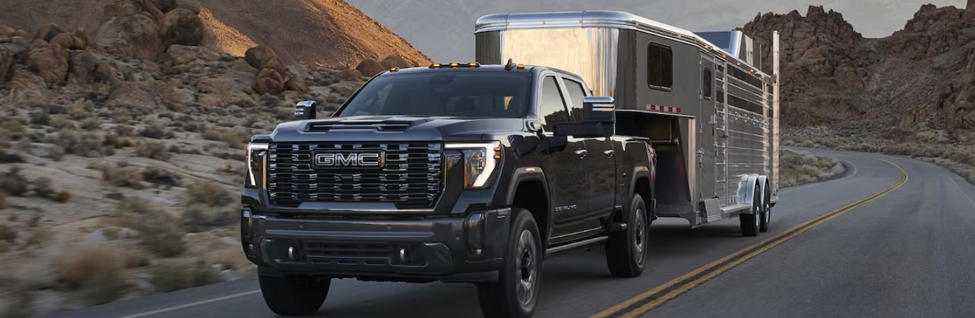 front quarter view of the 2025 GMC Sierra 3500 HD towing a trailer