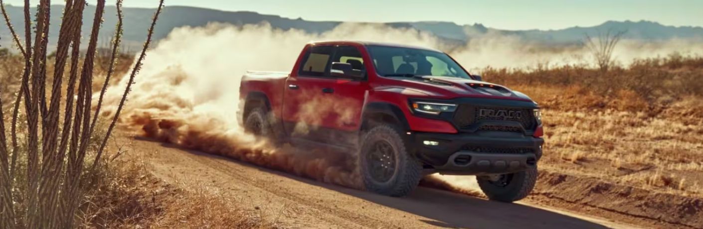 Side view of the 2024 Ram 1500 on a tough terrain