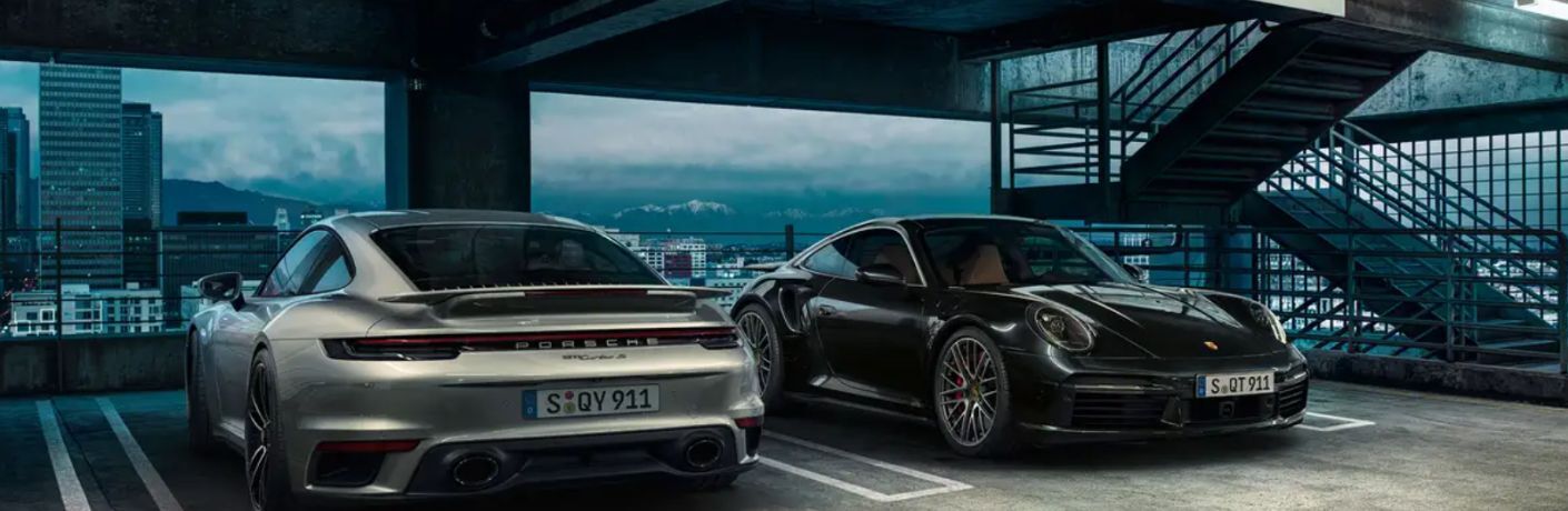 front view of a Porsche and rear view of a 2025 Porsche 911 Turbo parked next to each other