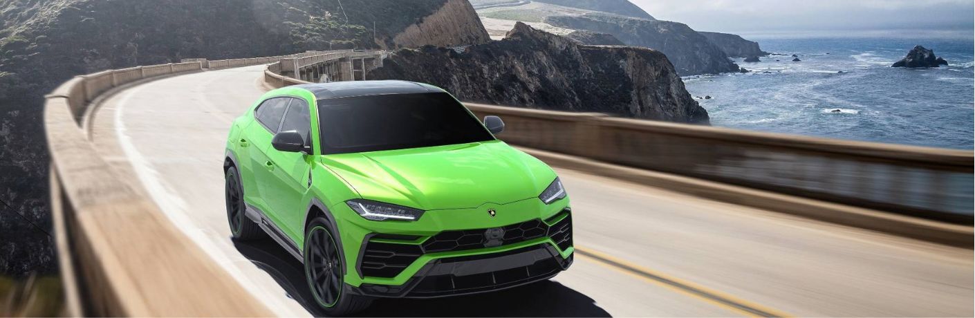 Lamborghini Urus Pearl Capsule in Verde Mantis driving along a coastal road