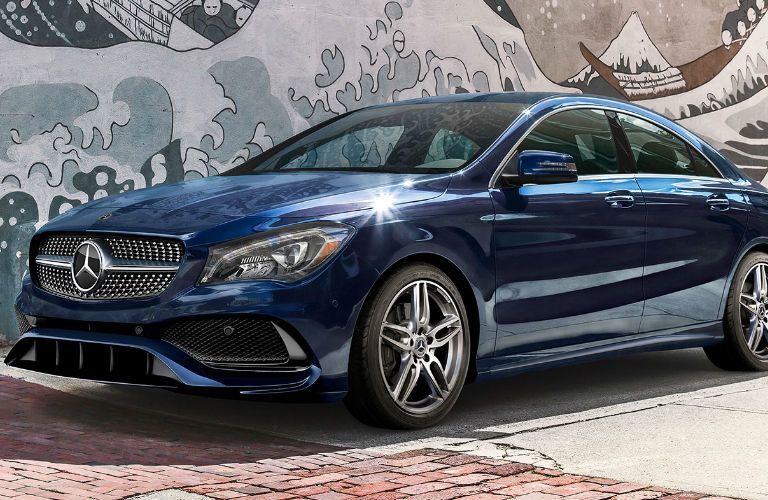 2019 Mercedes-Benz CLA Coupe parked in front of a wall with a painting of a wave of water