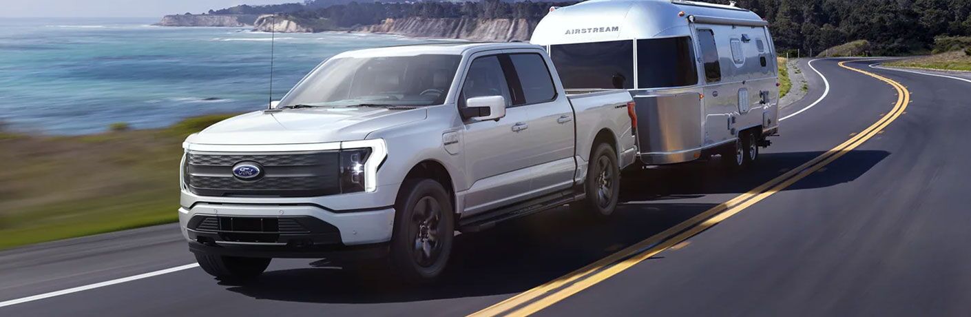 2022 Ford F-150 Lightning with a trailer by water