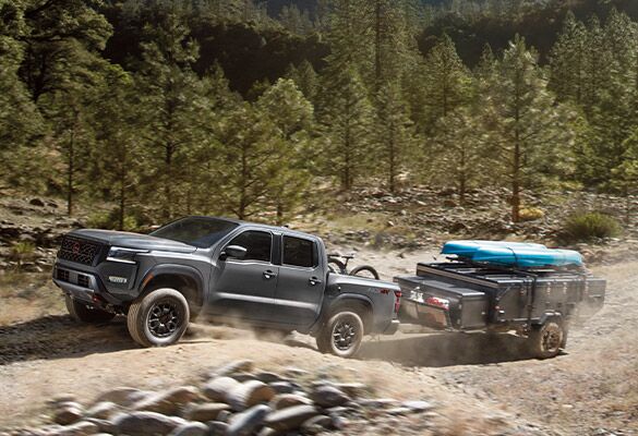 2023 Nissan Frontier pulling a trailer off-road.