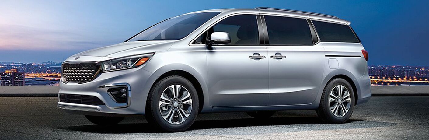 2020 Kia Sedona against a night city skyline