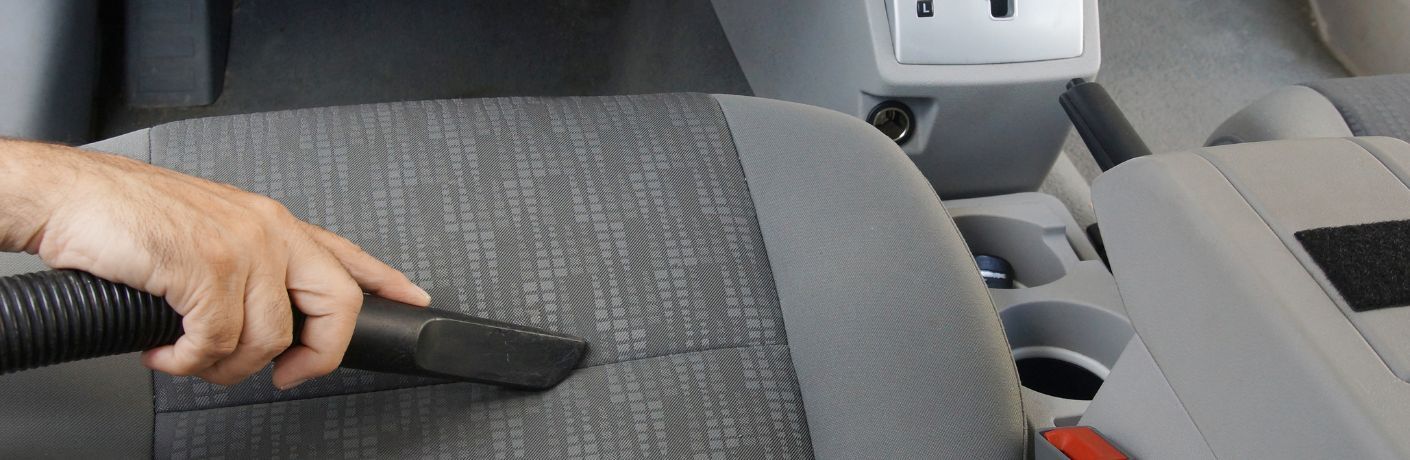 Technician undertaking interior upholstery cleaning