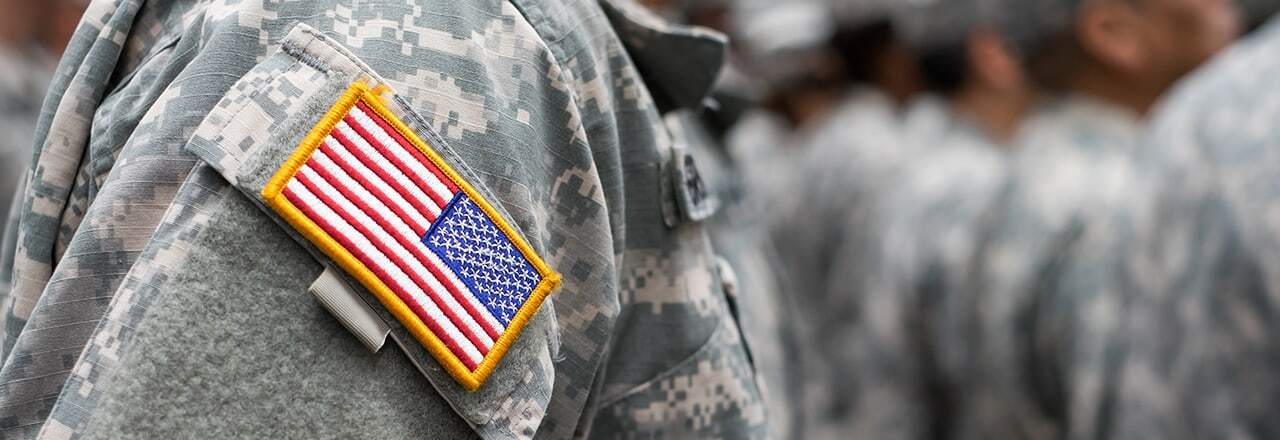 arm of soldier in uniform with American flag patch
