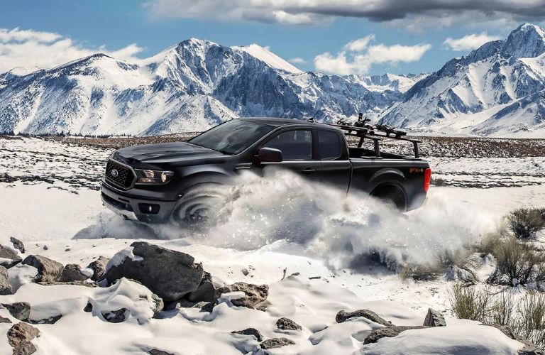 One black color 2023 Ford Ranger driving in snow
