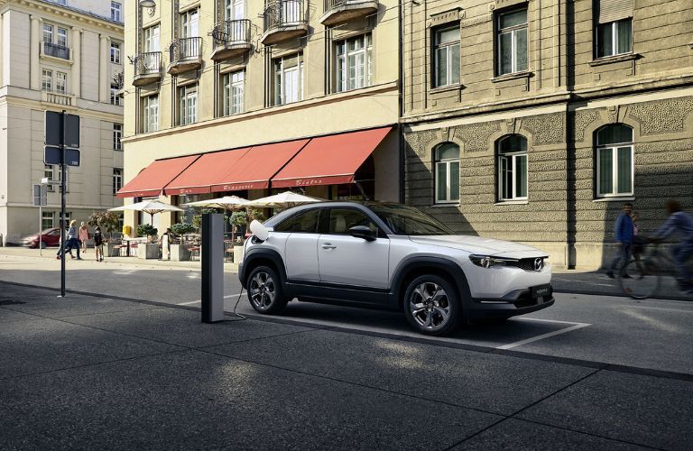 A 2022 Mazda MX-30 charged on a street