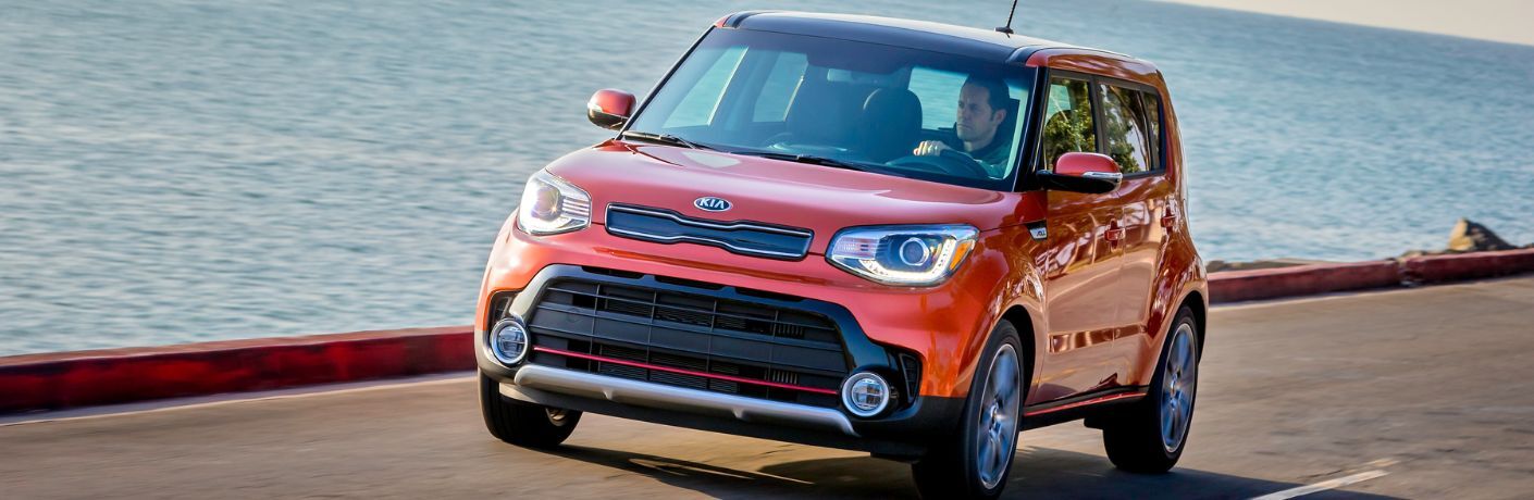 2019 Kia Soul being driven on a road next to a beach