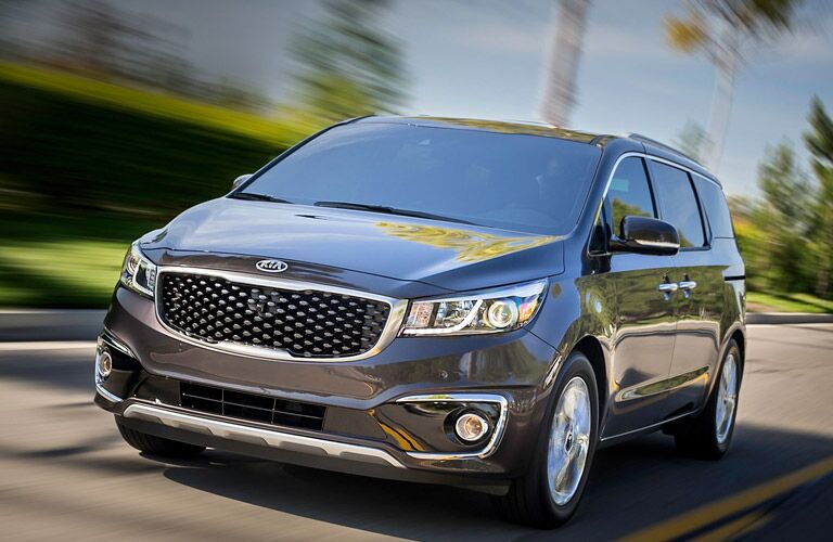 A 2016 Kia Sedona speeding on a road