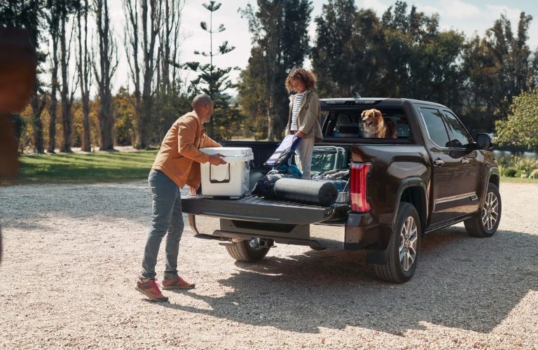 A family unloading cargo from the 2023 Toyota Tundra i-FORCE MAX 1794 Edition