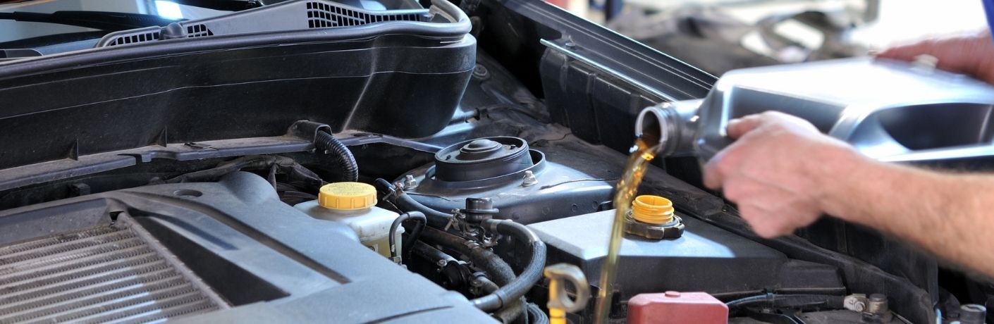 oil being poured into a car