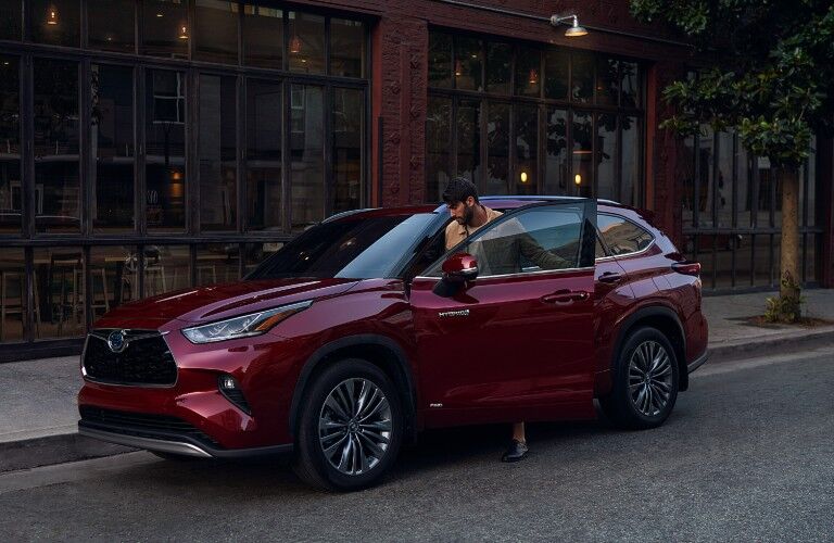 Front driver angle of a red 2021 Toyota Highlander Hybrid