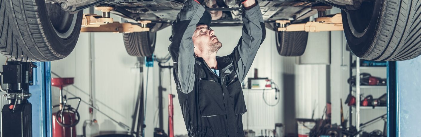 Man working on a vehicle bottom