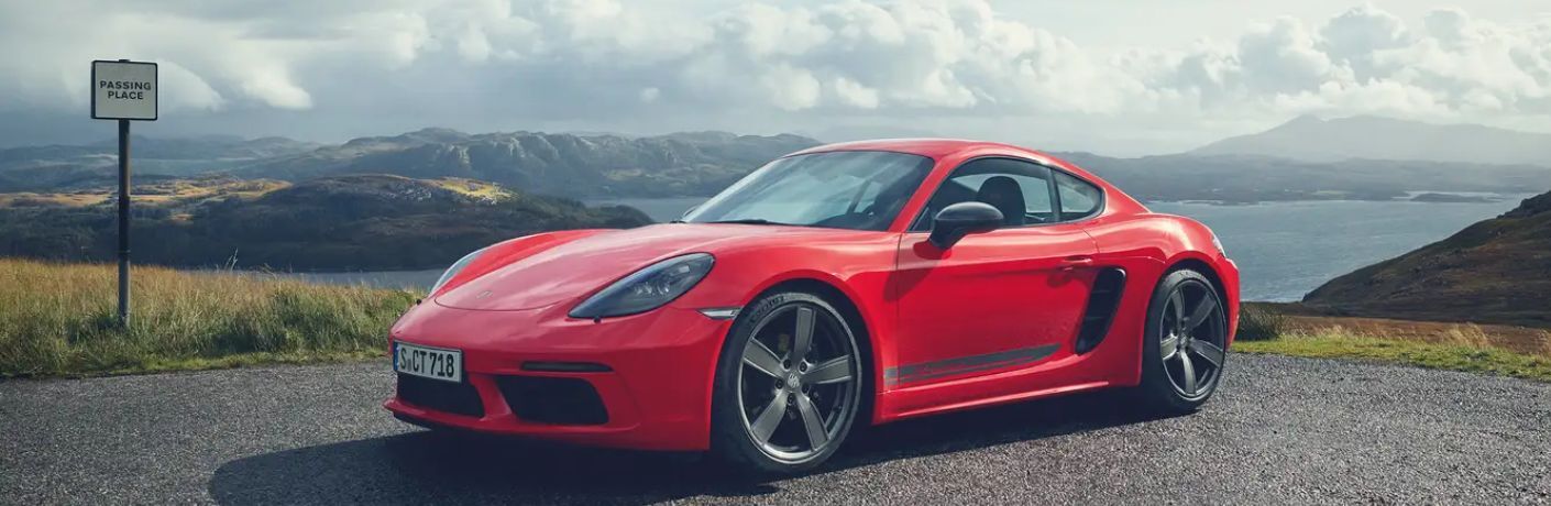 An image of the side view of a red colored 2023 Porsche 718 Boxter.