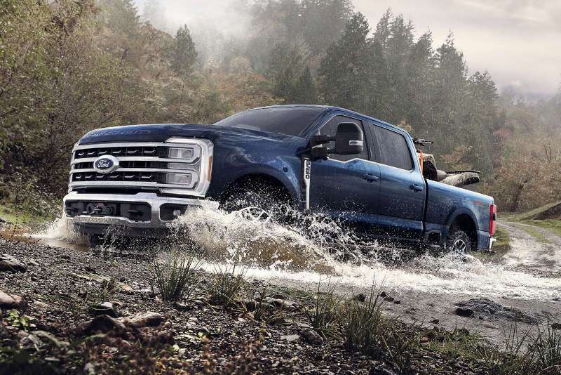 A Ford F-250 fording a stream