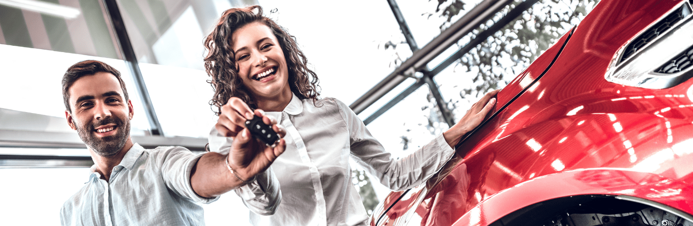 A couple posing for a picture with their key