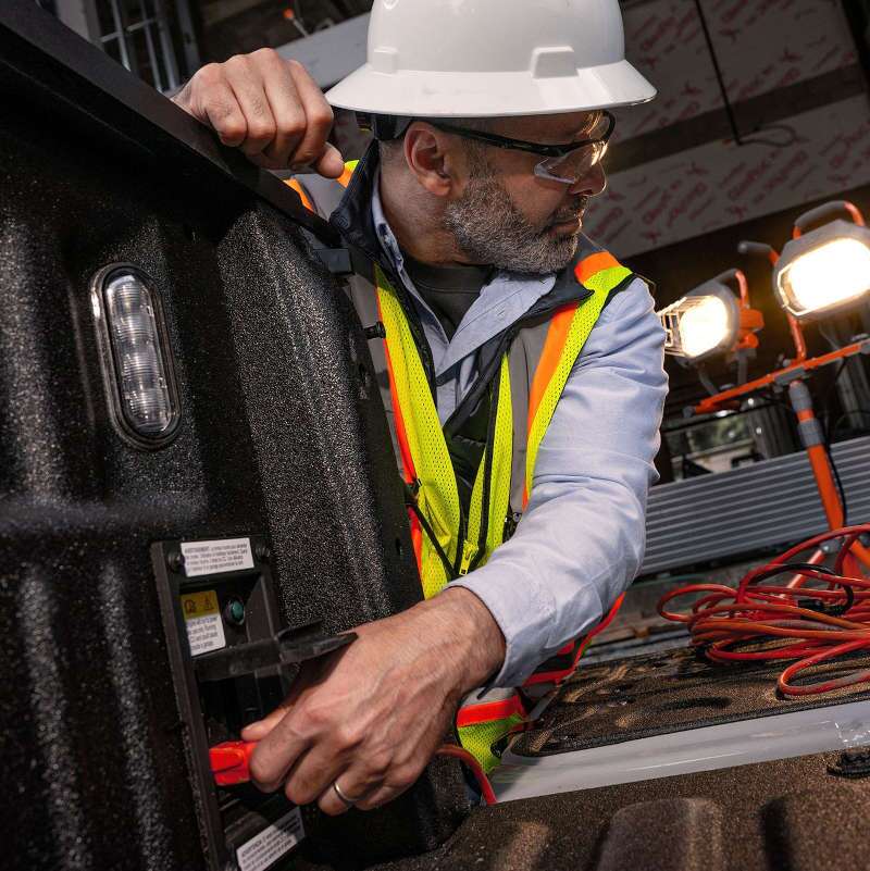 A man using the power station in a 2026 Ford F-450