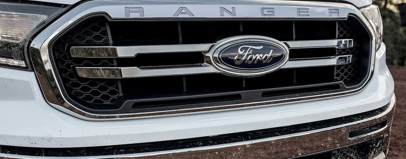 A close up of the grille on a white 2023 Ford Ranger at a used car dealership near Hackensack.
