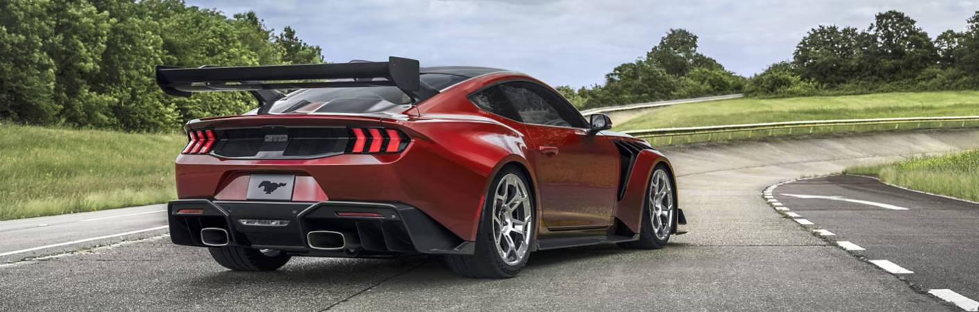 A rear quarter view of the 2025 Ford Mustang GTD on a race track.