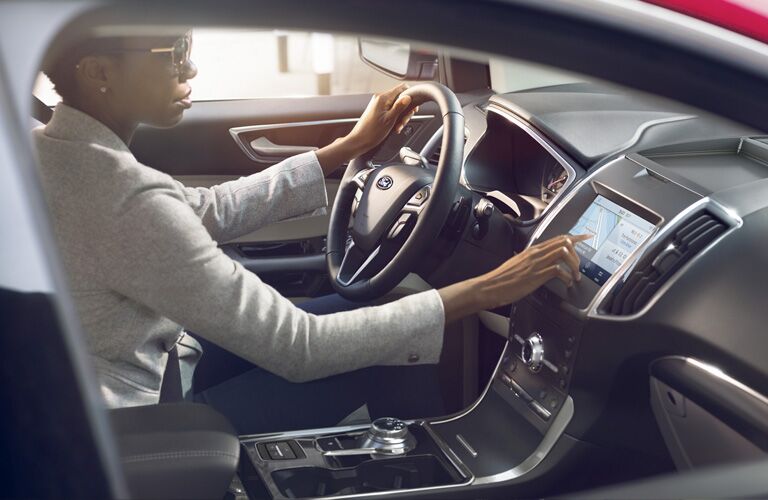woman using 2020 Ford Edge touchscreen