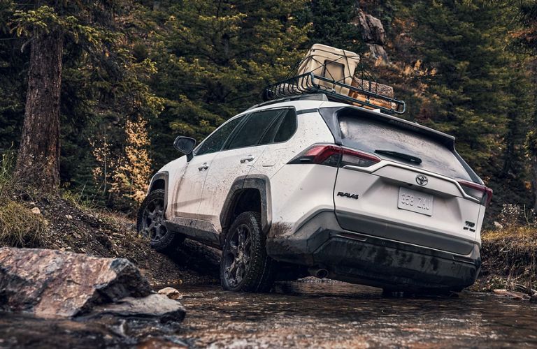 Rear view of the 2024 Toyota RAV4 navigating difficult terrain