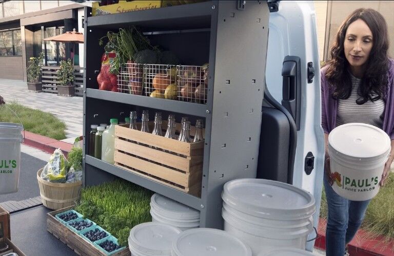 2024 Ford Transit Connect shelving with a woman