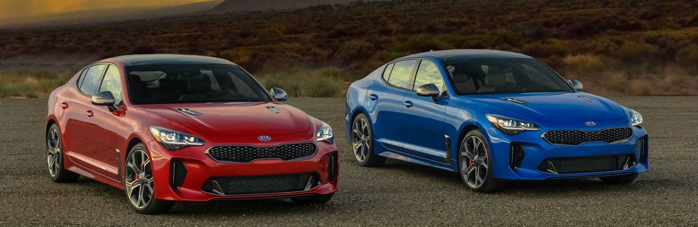 Red and Blue 2021 Kia Stinger Models on a Desert Road
