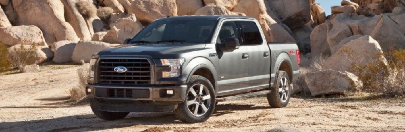 The 2015 Ford F-150 backdropped by rocks in a sunny day