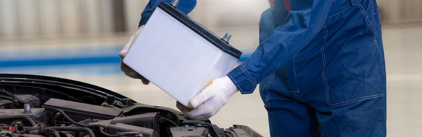 Mechanic replacing a car battery