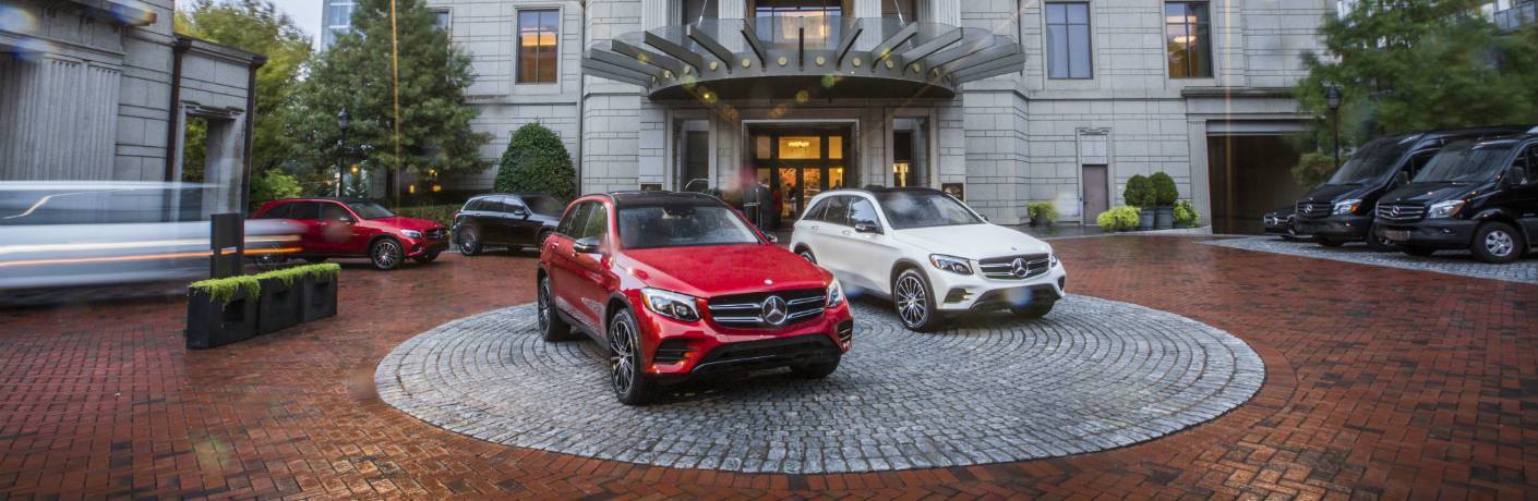 Mercedes-Benz SUVs parked in front of fancy hotel