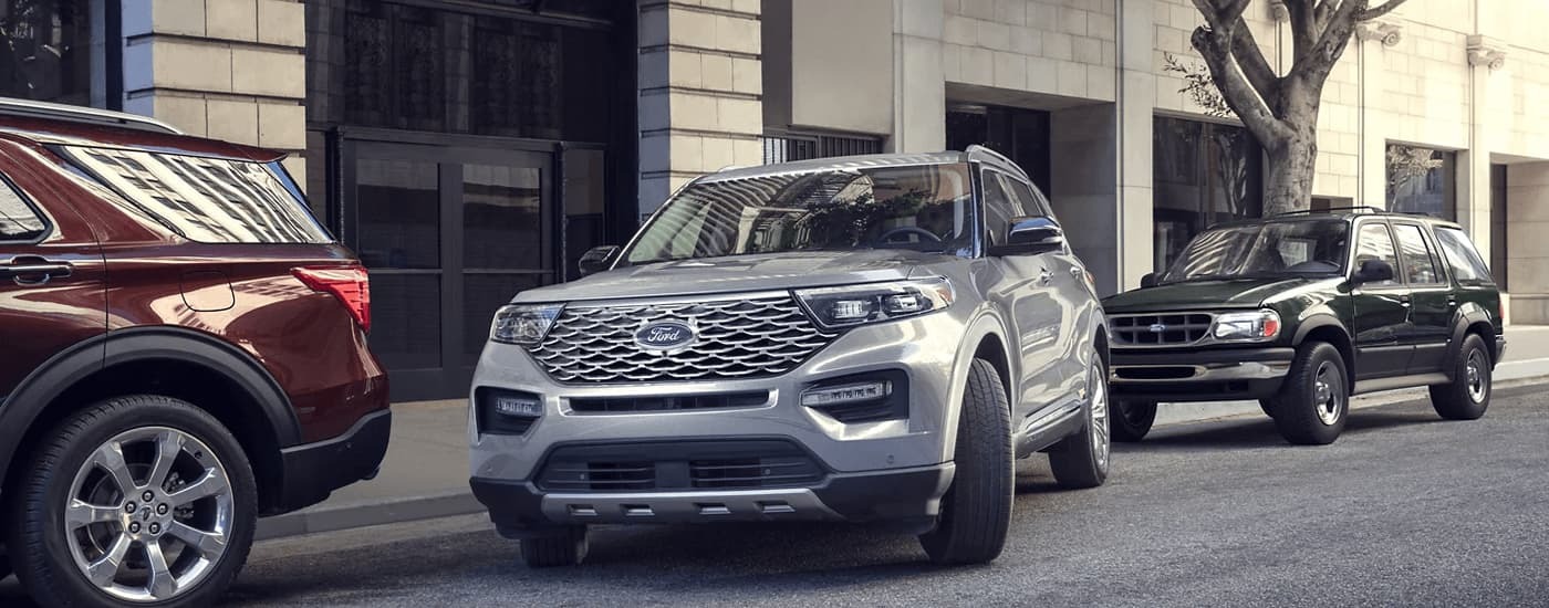 Silver 2023 Ford Explorer parallel parking in a city.