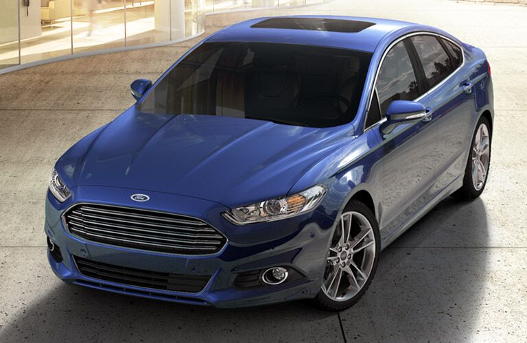 Front aerial angle of a dark blue 2014 Ford Fusion